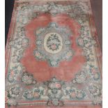 Large Chinese style carpet, central foliate medallion over pink ground, foliate boarder,