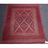 Tribal Gazak rug with central diamonds over red ground,