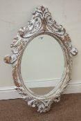 Ornate painted French style oval wall mirror,