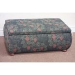 Upholstered ottoman with hinged top, raised on bun feet,