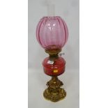 19th/ early 20th Century oil lamp with cranberry glass well and shade,