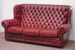 Three seat wingback sofa upholstered in buttoned oxblood leather,