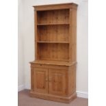 Solid pine bookcase fitted with two adjustable shelves on double cupboard, W96cm, H199cm,