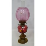 19th/ early 20th Century oil lamp with cranberry glass well and shade,