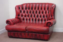 Two seat wingback sofa upholstered in buttoned red leather,