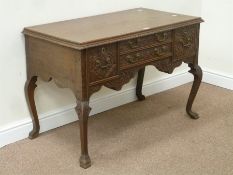 Victorian carved oak lowboy/desk fitted with four drawers,