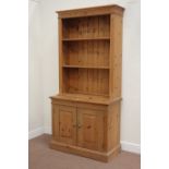 Solid pine bookcase fitted with two adjustable shelves on double cupboard, W96cm, H199cm,