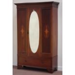 Edwardian wardrobe enclosed by single door with oval bevel edged mirror, single drawer to base,