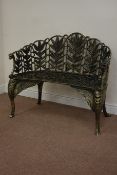 Bronzed finish heavy cast iron curved back bench, decorated with foliage and wings,