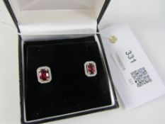 Pair of oval ruby and diamond cluster white gold ear-rings stamped 750 Condition Report