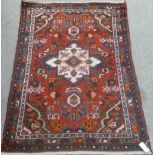 Hamadan rug, central rosette over red ground floral design, spandrels and boarders,