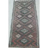 Baluchi long rug, with all over dog tooth diamond design, over black ground,