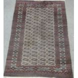 Bokhara Turkoman design carpet, with four rows of eighteen guls over grey ground, multiple boarders,