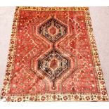 Shiraz carpet with double hexagon over red ground floral border 182cm x 150cm Condition