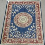 Keshan motif carpet / wall hanging, central medallion over blue ground floral spandrels,