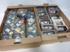 A collection of Vitesse Diecast model rally cars in display cases,