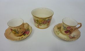 A pair of Royal Worcester blush ivory miniature cup and saucers and a Royal Worcester ivory blush