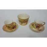 A pair of Royal Worcester blush ivory miniature cup and saucers and a Royal Worcester ivory blush