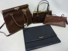 Four leather ladies bags including a large navy blue clutch bag,