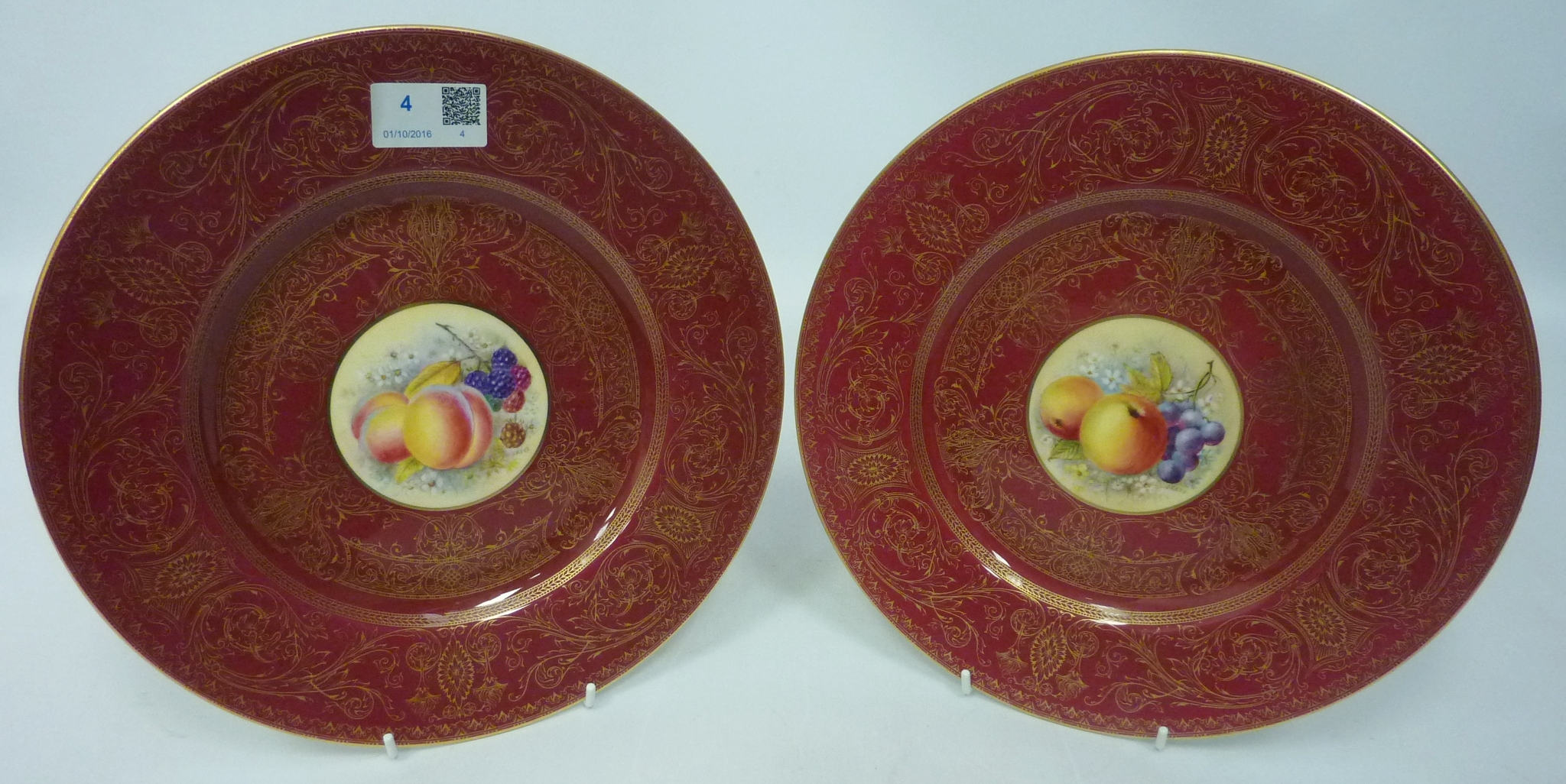 Pair of Royal Worcester plates with hand-painted panels of fruit by J.