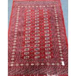 Persian Bokhara design red ground rug,