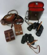 Cased set of binoculars, leather cased brush set,