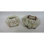 Two 19th Century porcelain baskets encrusted with flowers and foliage.