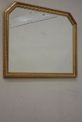 Gilt framed overmantle mirror fitted with bevelled glass,
