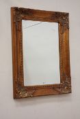 Rectangular bevelled mirror in swept gilt frame,
