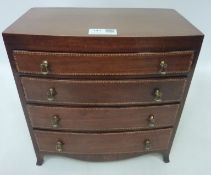 20th century Georgian style miniature mahogany bow front chest fitted with four graduating drawers