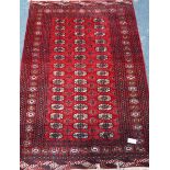 Persian Bokhara design red ground rug,