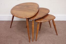 Ercol nest of three pebble elm top tables, raised on tapering legs,