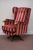 Swivel beech and oak framed wingback armchair upholstered in Romo striped fabric,