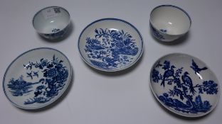 Two first period Worcester tea bowls and saucers and an additional saucer decorated with birds