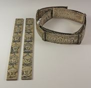 Two Chinese emperor white metal paper weights and a white metal belt Condition Report