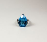 Large pear shaped blue topaz ring with diamonds to each side and shoulders hallmarked 18ct ( topaz
