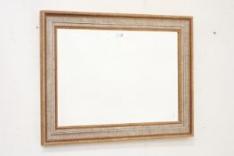 Contemporary wall mirror, moulded rectangular frame enclosing bevelled glass plate,