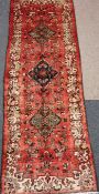 Hamadan long rug, three floral medallions over red ground with floral decoration,