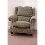 Parker Knoll wing back armchair in green and beige patterned cover,