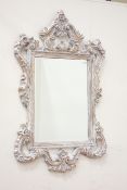 Ornate French style mirror fitted with bevelled glass,