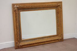 Gilt framed wall mirror,the moulded rectangular frame with floral decoration,