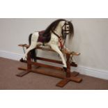 20th century painted rocking horse raised on mahogany trestle base,