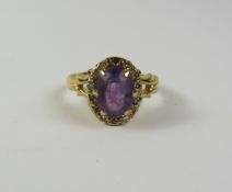 Amethyst and diamond cluster gold ring the fancy shank hallmarked 18ct Condition Report