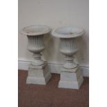 Pair small antique white finish cast iron garden urns on plinths, D30cm,