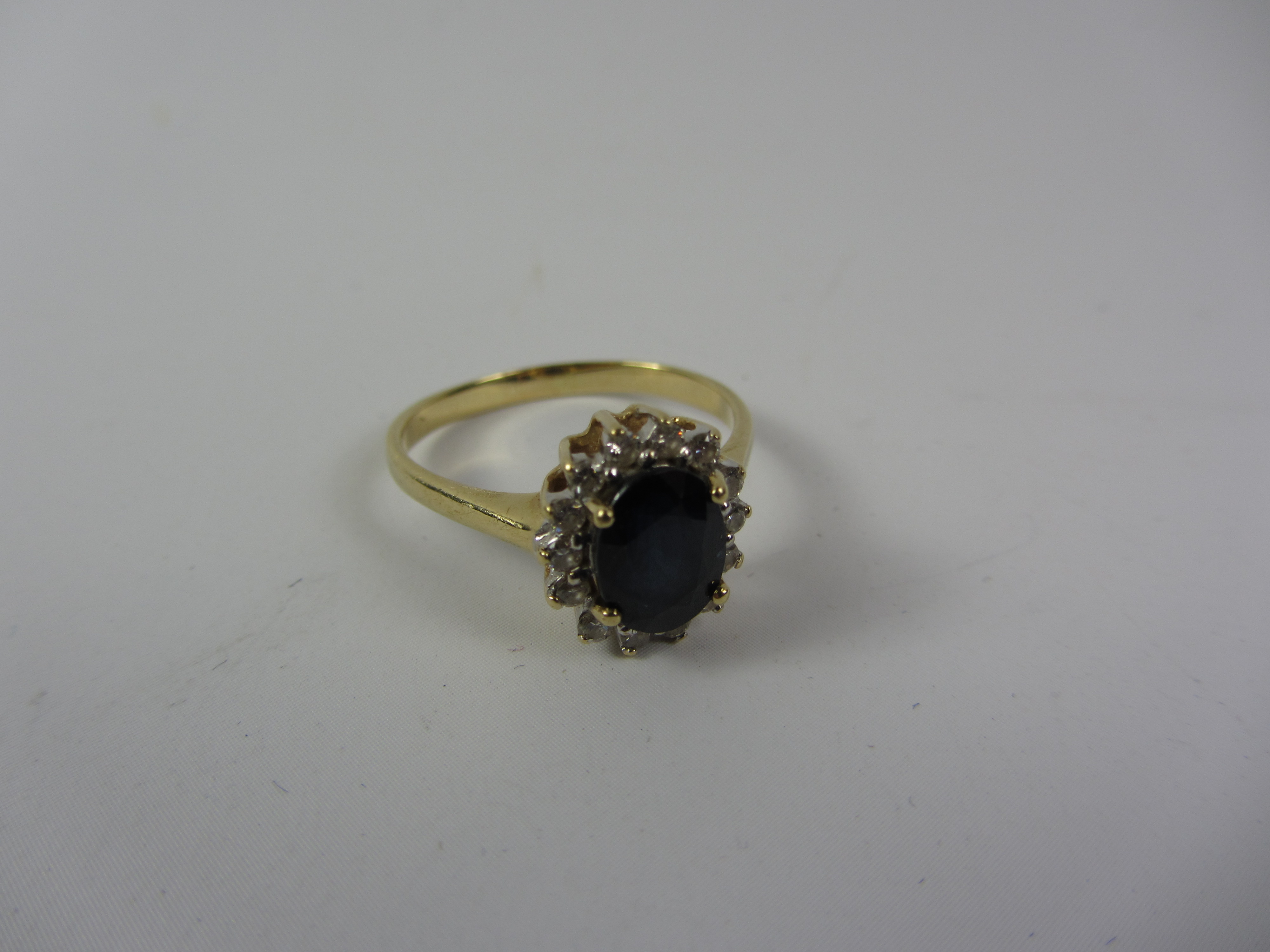 Sapphire and diamond cluster gold ring stamped 750 Condition Report <a