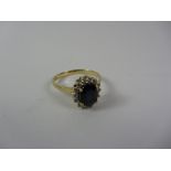 Sapphire and diamond cluster gold ring stamped 750 Condition Report <a