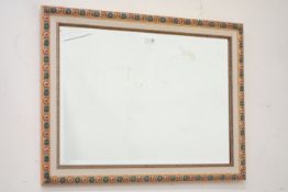 Wall mirror, with floral decoration, enclosing bevelled glass plate,