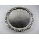 George III Scottish silver salver raised on three acanthus paw feet with floral embossed border and