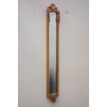 Moulded gilt framed mirror with bevelled glass, ribbon bow pediment,