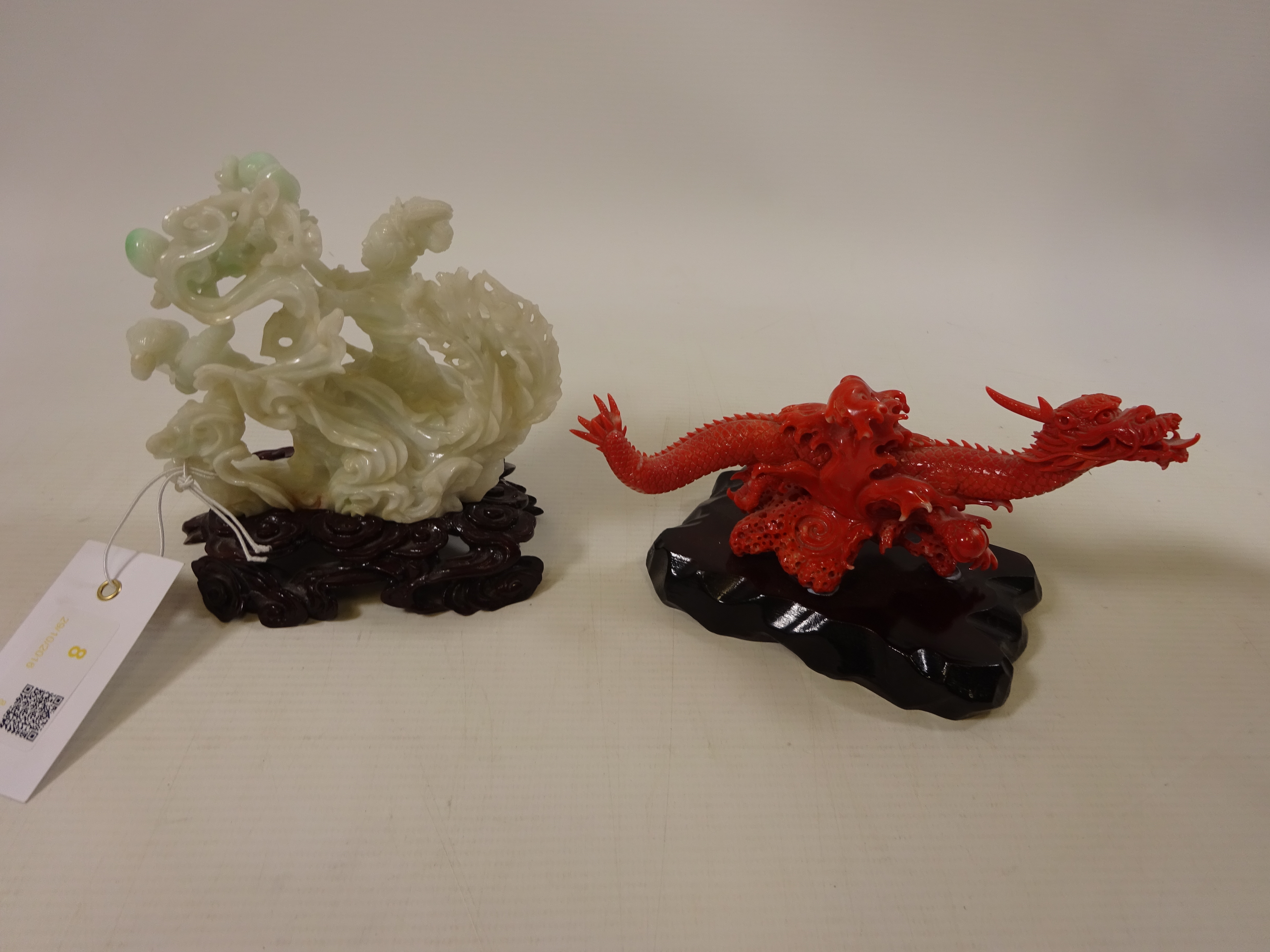 Chinese Jade carving of a lady and child with lotus flowers riding a phoenix and a coral carving of